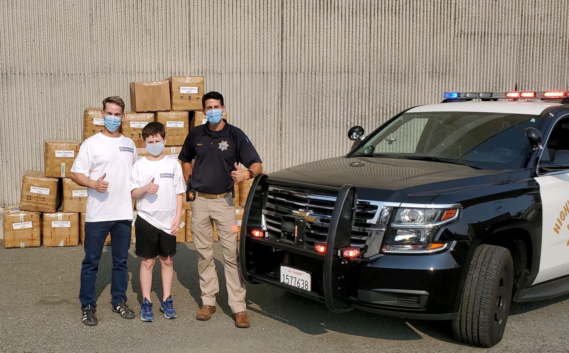 Bobby delivering donated masks to a CHP officer